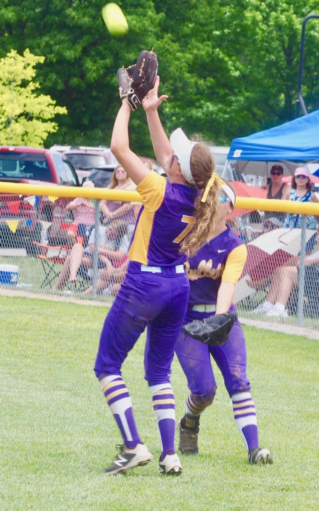 Emma Walbert catches a fly ball in center field.