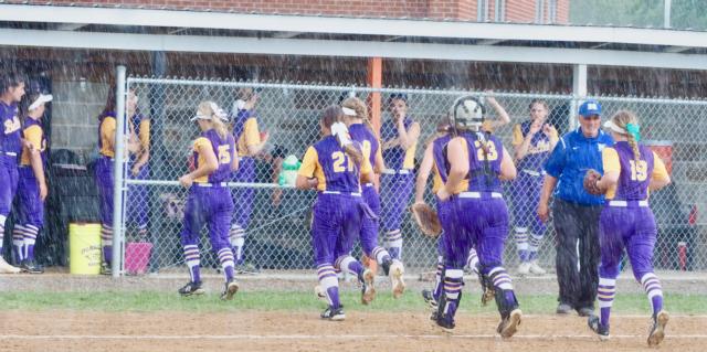 The Williamsville players evacuate the field as the rain comes down.