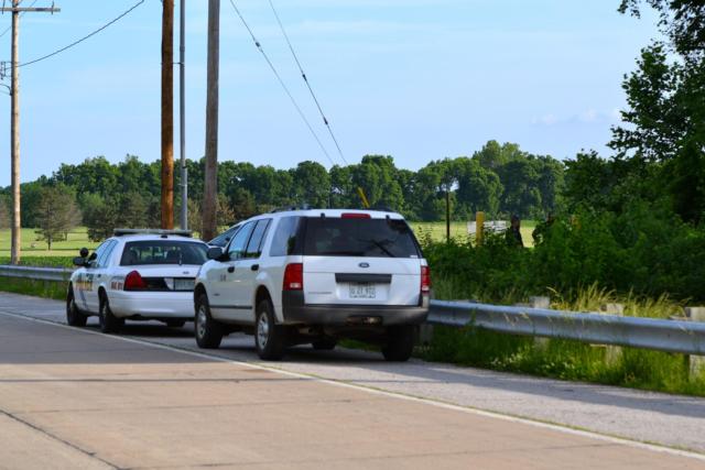 A Southern Illinois University-Edwardsville Police car and an unmarked vehicle are parked near the scene of a fatal construction accident on Thursday. (Photo by Dan Brannan)