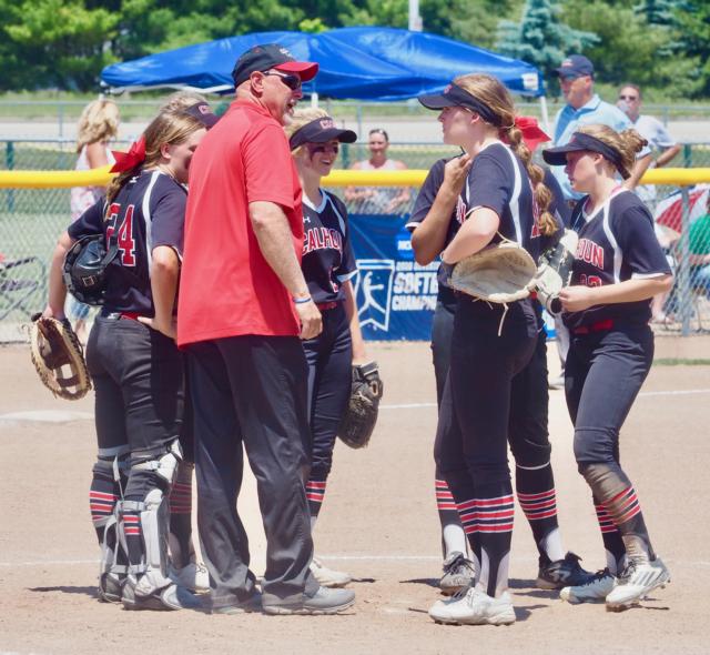 Duane Sievers and the Calhoun infield have a meeting in the circle.