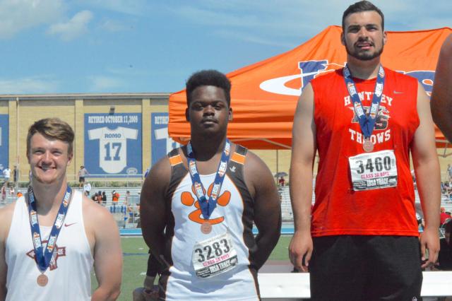 Edwardsville's Amari Brooks (middle) on the medal state at the state track and field meet. (Photo by Brent Feeney)