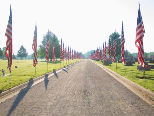 The beautiful Ave of Flags-Salute to Veterans display stands in honor & tribute on Memorial Day morning at the entrance rd to Sunset Hill Funeral Home & Cemetery.