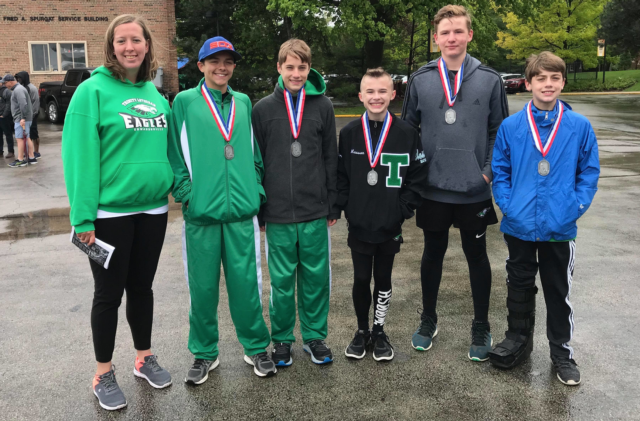 Trinity Coach Morgan DeBlieck and members of the boys 4x100 relay team that finished second at the state track meet in Chicago.