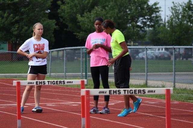 Edwardsville High School girls track and field coach MiKala Thompkins works with hurdlers on the first day of camp on Tuesday. (Photo by Madeline Gerard)
