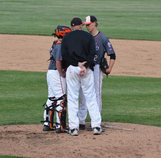 Joe Wallace and pitching coach Mike Waldo have a conversation with pitcher Chris Robinson on Wednesday in the regional game against O'Fallon. (Photo by Dan Brannan)