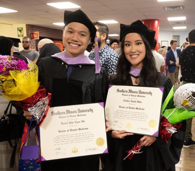 Graduates celebrating earning their degree from the SIU SDM.