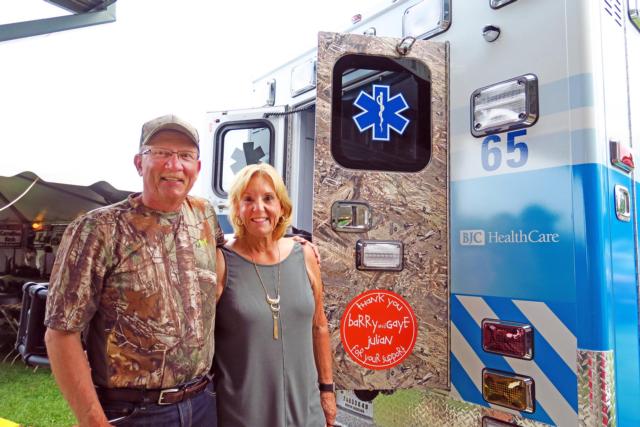 Barry and Gaye Julian stand next to the latest “Duck Plucker” ambulance, which honors their long-time support of the event.