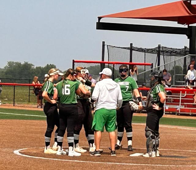 A gathering at the mound on Friday in Peoria for Carrollton girls softball. (Photo by Sherry Fraley).