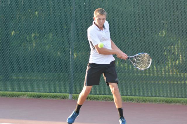 Carson Haskins returns a volley. (Photo by Dan Brannan)