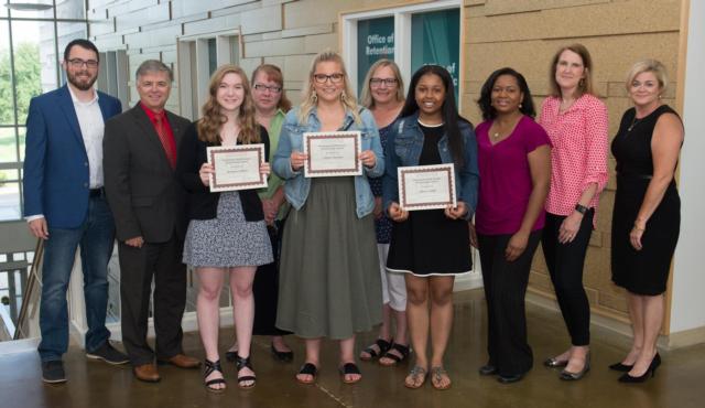 (L-R) SIUE Staff Senate Treasurer and Scholarship Chair Collin Van Meter, Chancellor Randy Pembrook, Maggie Haas, Stacey Haas, Taylor Hansen, Trish Hansen, Alexis Acoff, Fannie Acoff, Staff Senate President Gretchen Fricke, and SIU Board of Trustees Chair Amy Sholar. 