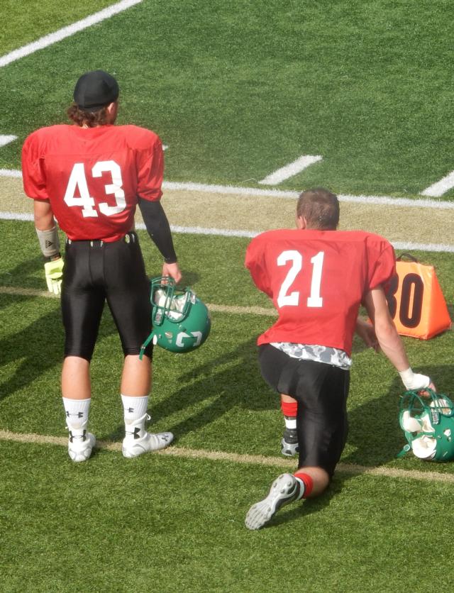 Carrollton's Jacob Smith, 43, and Cody Leonard 21, are next to each other on the sidelines on Saturday.