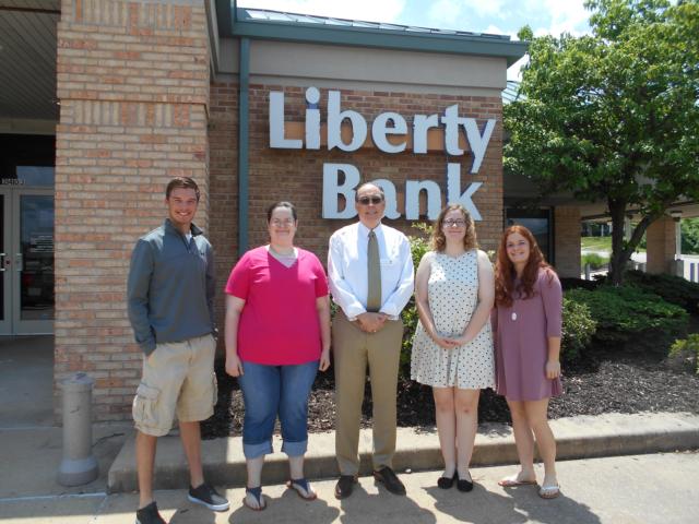 (from left to right): Brock Seymour of Southwestern HS, Kathleen Botterbush of Marquette Catholic HS, Liberty Bank President Dale Blachford, Anna Sawyer of Alton HS, Cassandra Reed of Civic Memorial HS