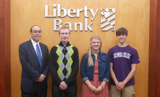 (From L to R) Liberty Bank President Dale Blachford, Civic Memorial High School’s Brett Norvell, Roxana High School’s Claire Bollinger and Marquette Catholic’s Brandon Root, unavailable and not pictured is Alton High School’s Mathew Quigley.