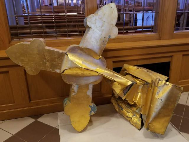 The fallen cross is now located at the entrance to the church. Photo provided by Father Paulin.