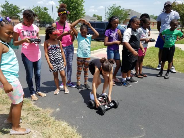 Meachum and Gateway resident participants work on building the rover, and practice operating it.