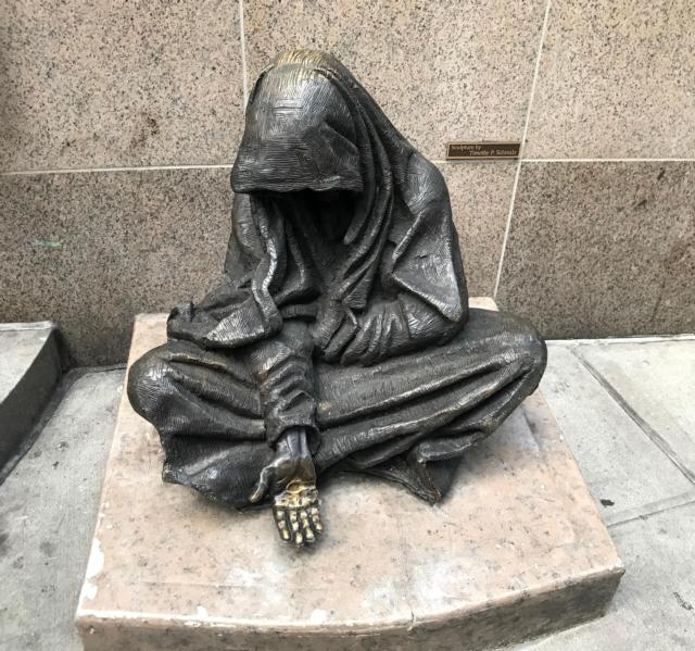 Bronze statue of the Homeless Jesus by sculptor Timothy Schmalz in front of St. Francis Church on 31st Street in Manhattan. Photo by Dan Brannan.