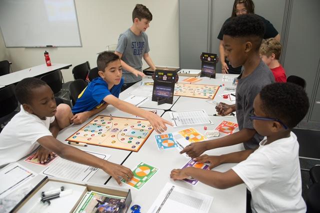 Participants in SIUE’s We Got Game: NBA Math Hoops camp work together to enhance their math skills through interactive learning.