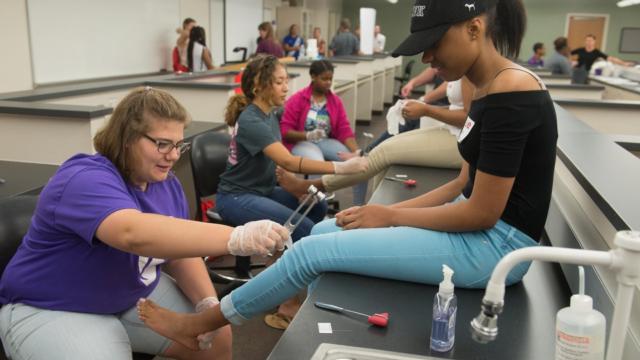 While visiting the SIUE School of Pharmacy, students performed foot exams on their peers to determine if they had pedal pulses and sensation in their feet and legs.