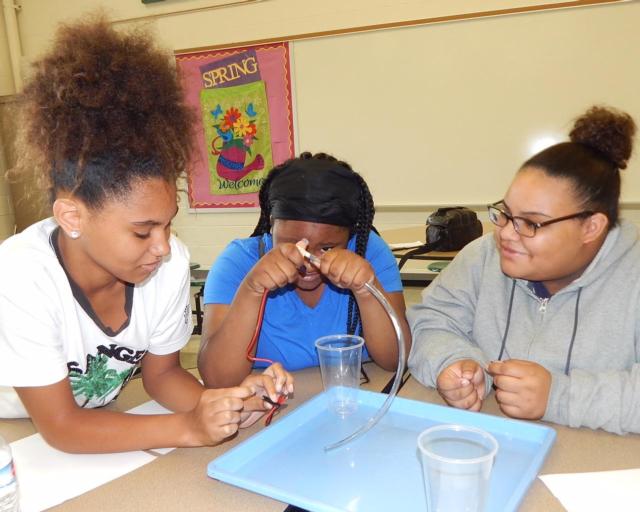 Tyrriah Parker, Amariyah McClenney and Nariah Bick construct a solar powered water pump.