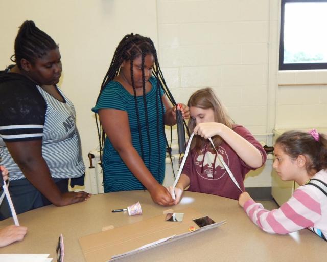 Elizabeth Sanders, I’Anna Hubbard, Kayloni Howes, Esra’a Ross Jaber take measurements to start building their prototype solar powered water pump.