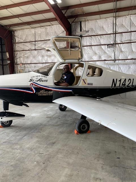 Raynard Nicholson, Principal of Madison Community Unit School District #12, sits in the cockpit of the New Spirit of St. Louis, part of the Charles Lindbergh exhibit non-profit AeroCareers brought to St. Louis Downtown Airport for Aviation Day for Educators. The exhibit also includes a full-scale reproduction of the original Spirit of St. Louis cockpit.