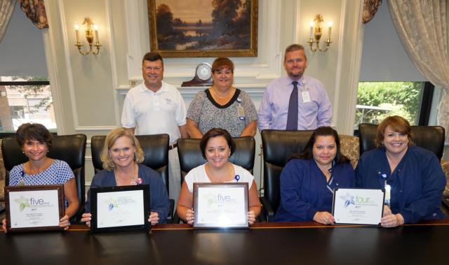 With the PRC Awards their departments earned this year are managers, seated left to right, Sue Walker of the Human Motion Institute; Amy Toenyes of the Digestive Health Center; Jessica Mossman of the Women’s Health and Childbirth Center; and Rebecca Miller and Cindy Bray of the Emergency Department. Standing behind them are, left to right, AMH President Dave Braasch; Debbie Turpin, vice president of Patient Care Services; and Brad Goacher, vice president of Operations.