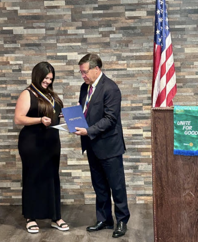 Steve Thompson presents the Paul Harris Fellowship Certificate to Alton Godfrey Rotary Honorary Member and Executive Secretary Katie Sabolo.
