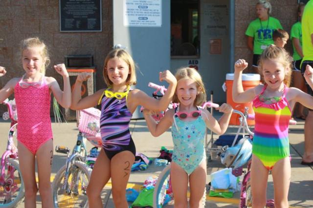 Left to Right: Corah Derrick, then age 8, Jovee Hileman, then age 8, Islee Hileman, then age 6, and Maleah Derrick, then age 6, are warming-up before the race at the 2015 Jersey Junior Tri!