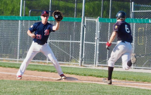 Cullen McBride catches a throw from Ethan Kopsie to record an out at first base.