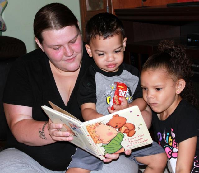 Jessica Lewey reads to two of her children, Braden and Aubree, during a home visit with a staff member from Riverbend Head Start & Family Services. Reading to your children is one of the activities the program promotes to encourage parents to be their children’s first teachers.