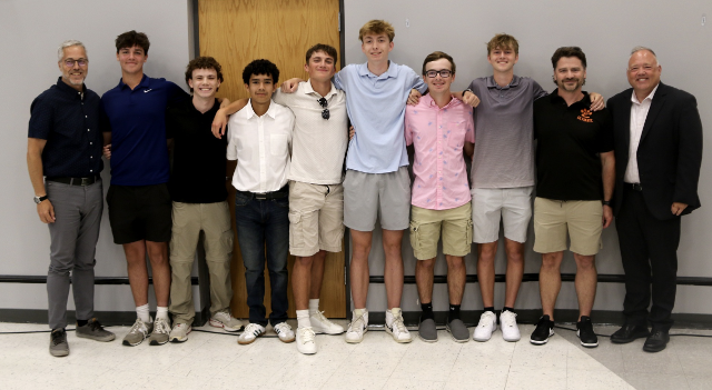 Ultimate frisbee team members pose with Superintendent Dr. Patrick Shelton and Board of Education President Bob Paty. Photo by Mary Ann Mitchell.