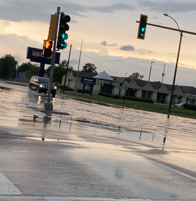 A motorist drives through high water in Granite City.