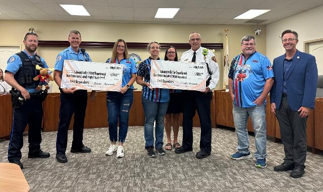 Members of the Edwardsville Moose Lodge present $2,800 checks to the Edwardsville Police and Fire Departments.