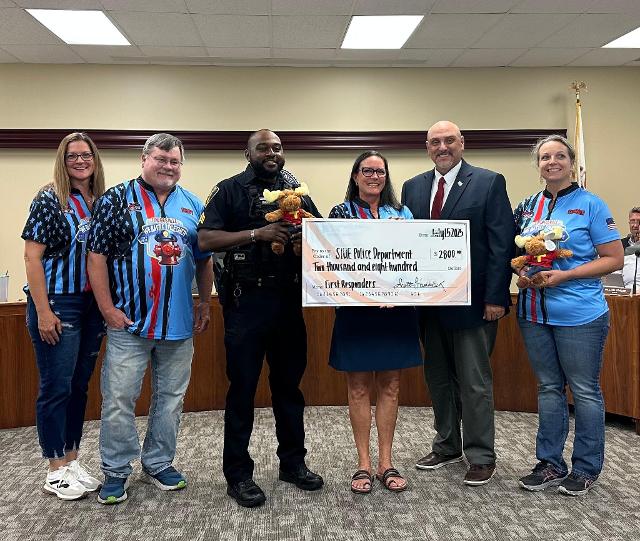 Members of the Edwardsville Moose Lodge present a $2,800 check to the SIUE Police Department.