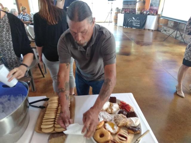 A man enjoying some of the pastries provides by Collinsville-based Kruta Bakery, which is being named as part of the state's Illinois program.