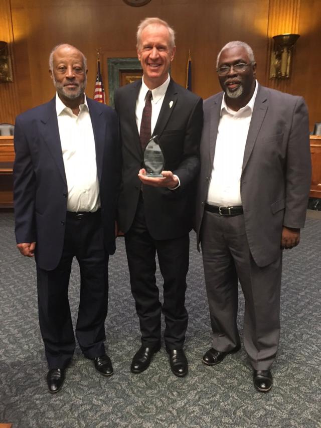 Gov. Bruce Rauner traveled to Washington, D.C., to address the National Black Chamber of Commerce during the group&rsquo;s 26th annual conference, where he was awarded the prestigious Arthur A. Fletcher Lifetime Achievement Award. Shown (from left) are Harry Alford, president and CEO of the National Black Chamber of Commerce, Rauner (holding award), and Larry Ivory, president and CEO of the Illinois Black Chamber of Commerce. 