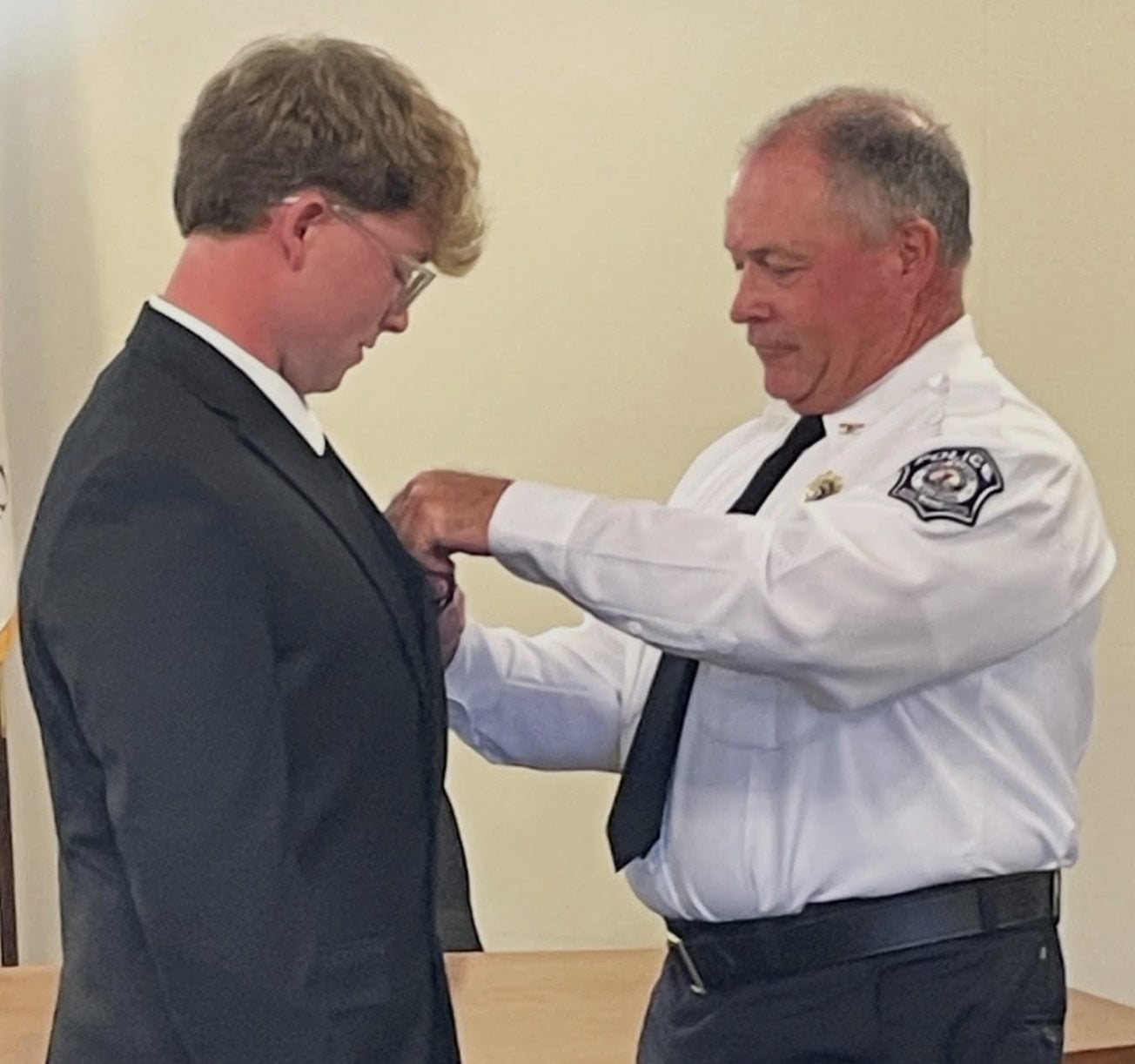 Officer Andrew Heil-Watson is shown being pinned by East Alton Police Chief Scott Golike as a new officer..