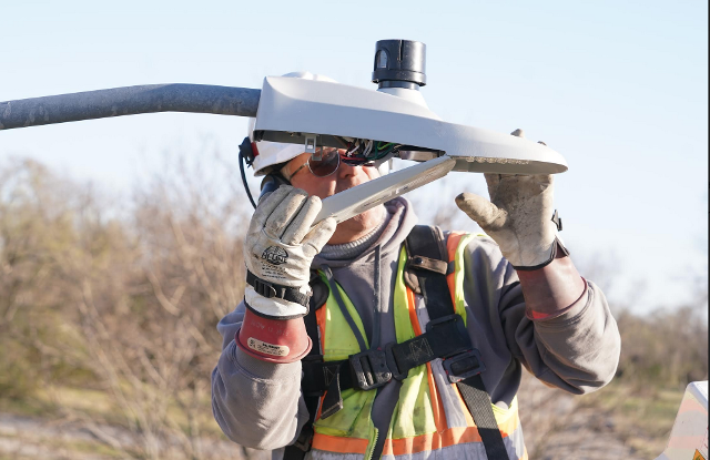 Max Lessard of Pro Electric installs a new LED streetlight. Ameren Illinois has contracted with Pro Electric to perform this replacement with the help of IBEW-trained electrical workers.