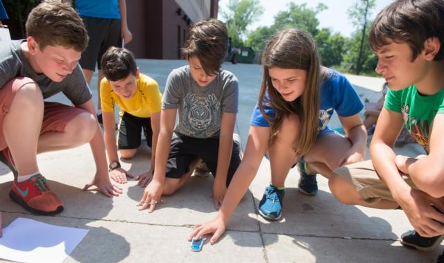 (L-R) Adam Johnson, Trevor McGeehan, Lucas Schardt, Maddie Burkart and Drew Klingsick get ready to test a solar car during an experiment.
