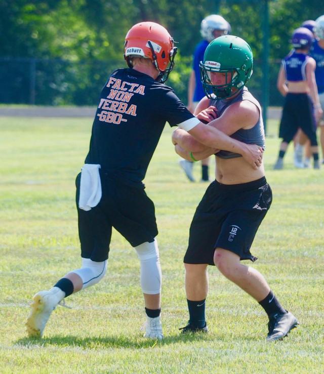 Byron Holmes (green t-shirt) getting tackled by a player from Gillespie at the Carrollton Hawk Pride 7-on-7.