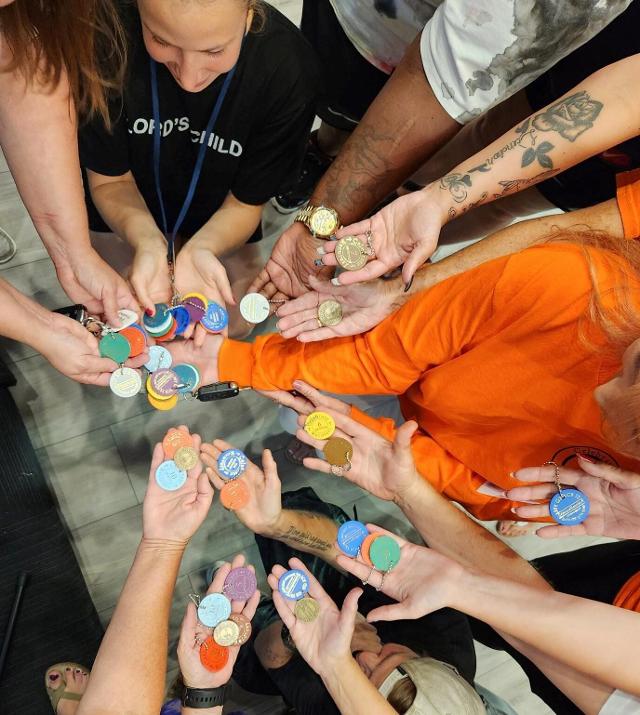 The Celebrate Recovery group from Wednesday, July 26 shows off their chips and coins.