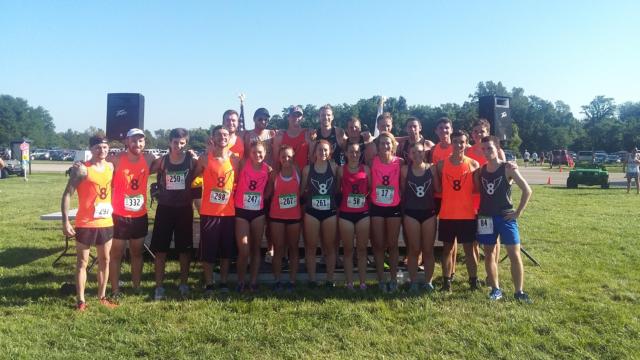 Edwardsville cross country alums stand in for the annual Mud Mountain photo. (Photo by Brent Feeney)