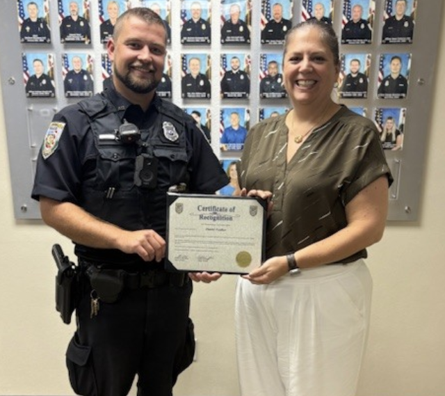 Swansea Police Officer Daniel Voelker receives a Certificate of Recognition.