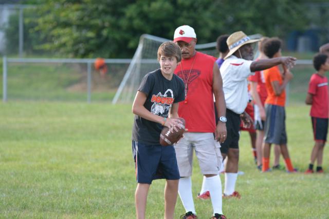 Coach Terry Mitchell works with players at the Alton Middle School Football Camp. (Photos by Dan Brannan)