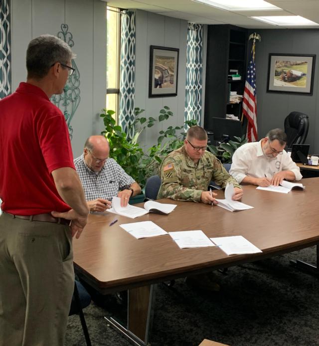 On Friday, Hal Graef, project manager with the U.S. Army Corps of Engineers St. Louis District presents information to Wood River Drainage and Levee District President Ron Carnell, Metro East Sanitary District Director Stephen Adler, Southwestern Illinois Flood Prevention District Chief supervisor Chuck Etwert and U.S. Army Col. Bryan K. Sizemore, commander of the St. Louis District and Madison County Board Chairman Kurt Prenzler on the new partnership agreement for the Wood River Levee System reconstruction project.
