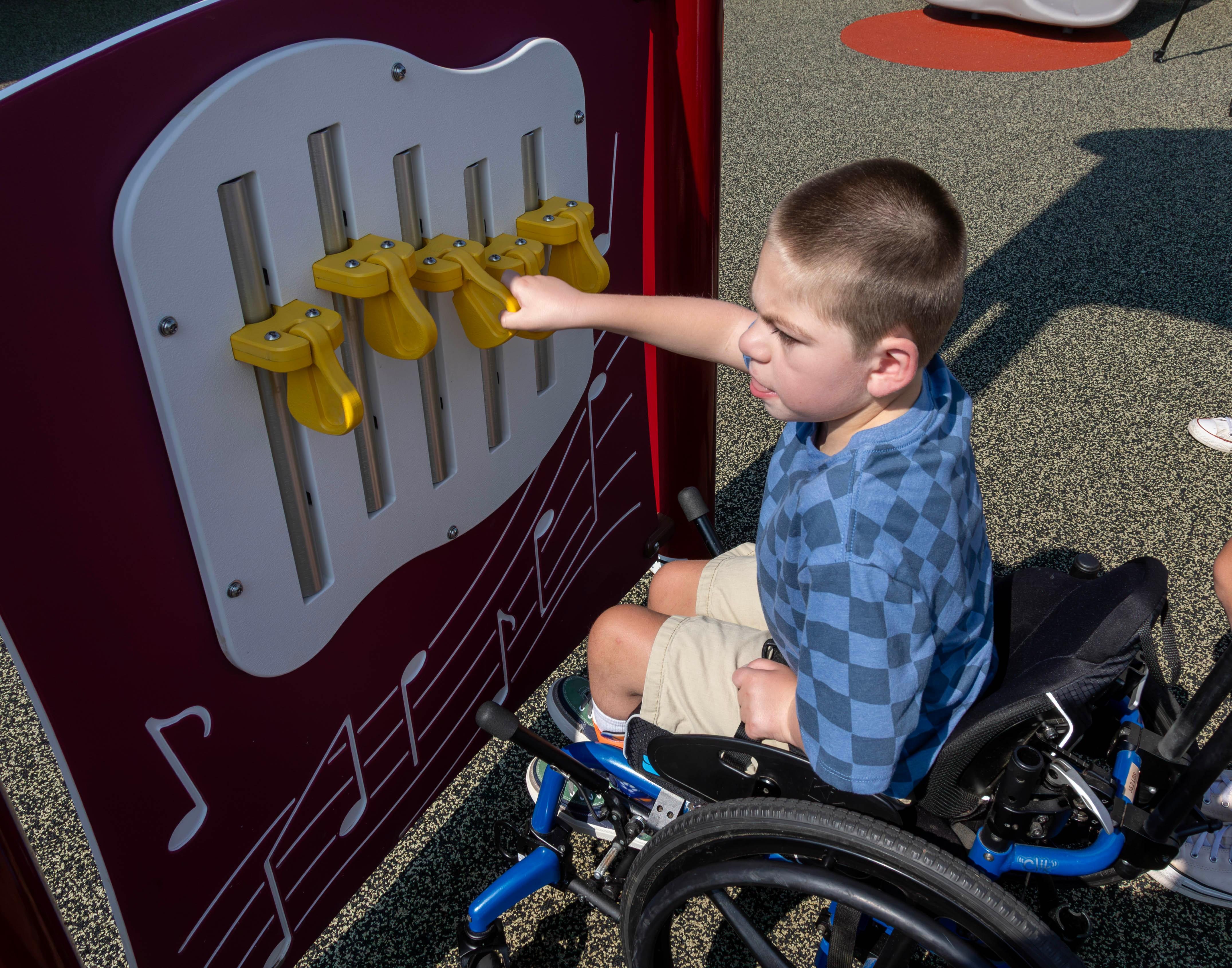 Henry Dunn makes music with the interactive chime panel.