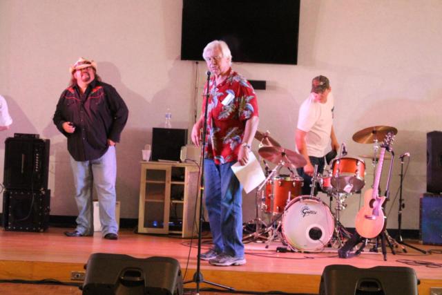 Mike Bortko, the event's organizer, addresses the crowd between performances. 