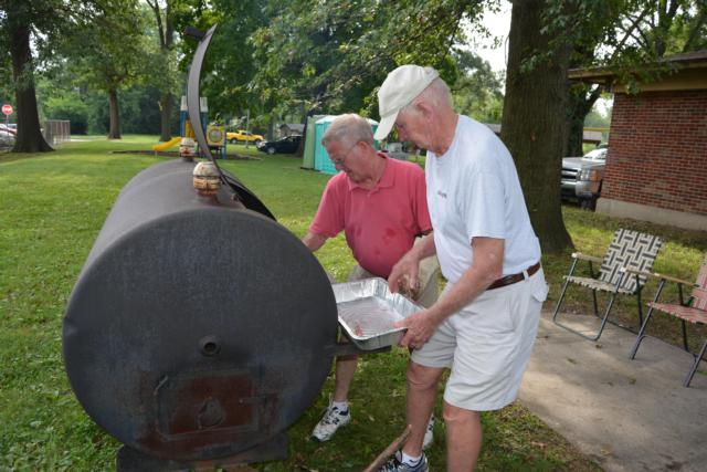 Don Huber prepares some of his 800 hot dogs at the Back To School, Stay In School day on Saturday.