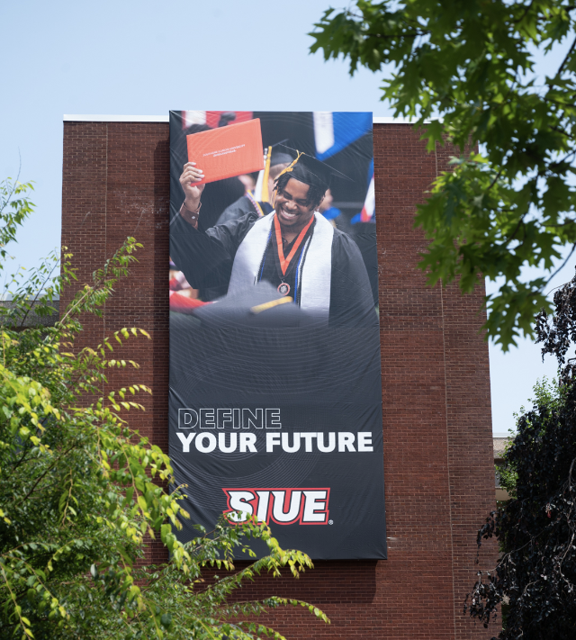  Class 2028 first-year photo, Welcome Week at SIUE, August 2024; Define Your Future banner at Lovejoy Library.