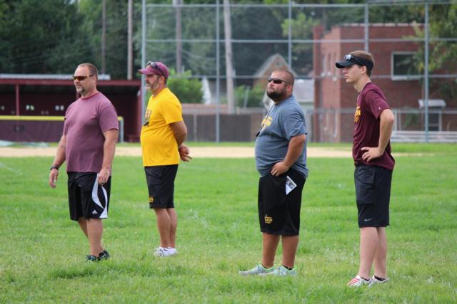 The EAWR coaching staff looks on as the boys in maroon and gold practice for the upcoming season. 